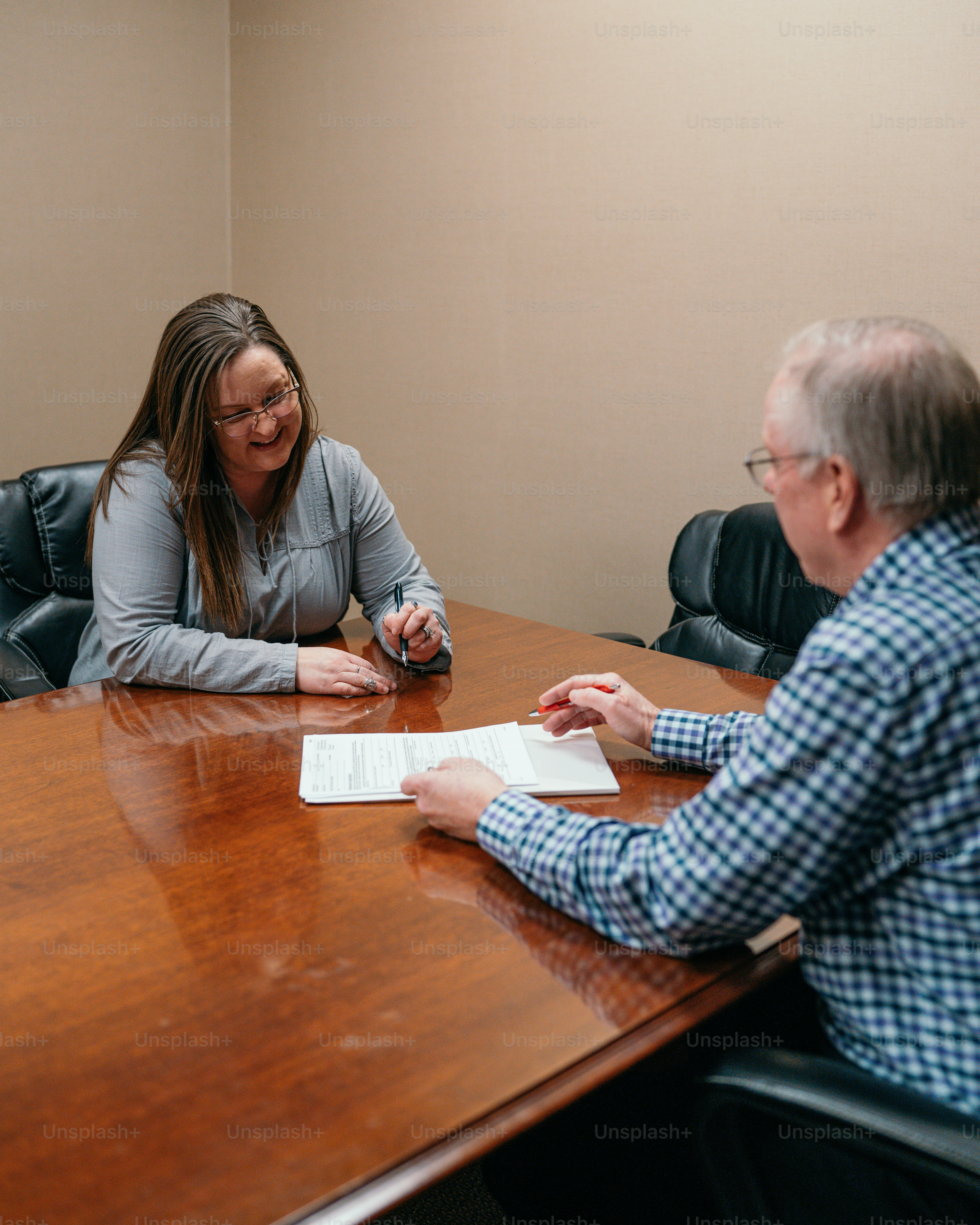 a man and a woman sitting at a conference table