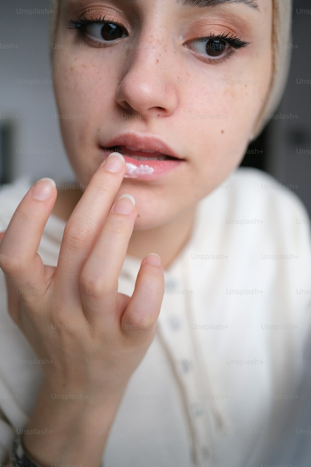 a close up of a person with a ring on her finger