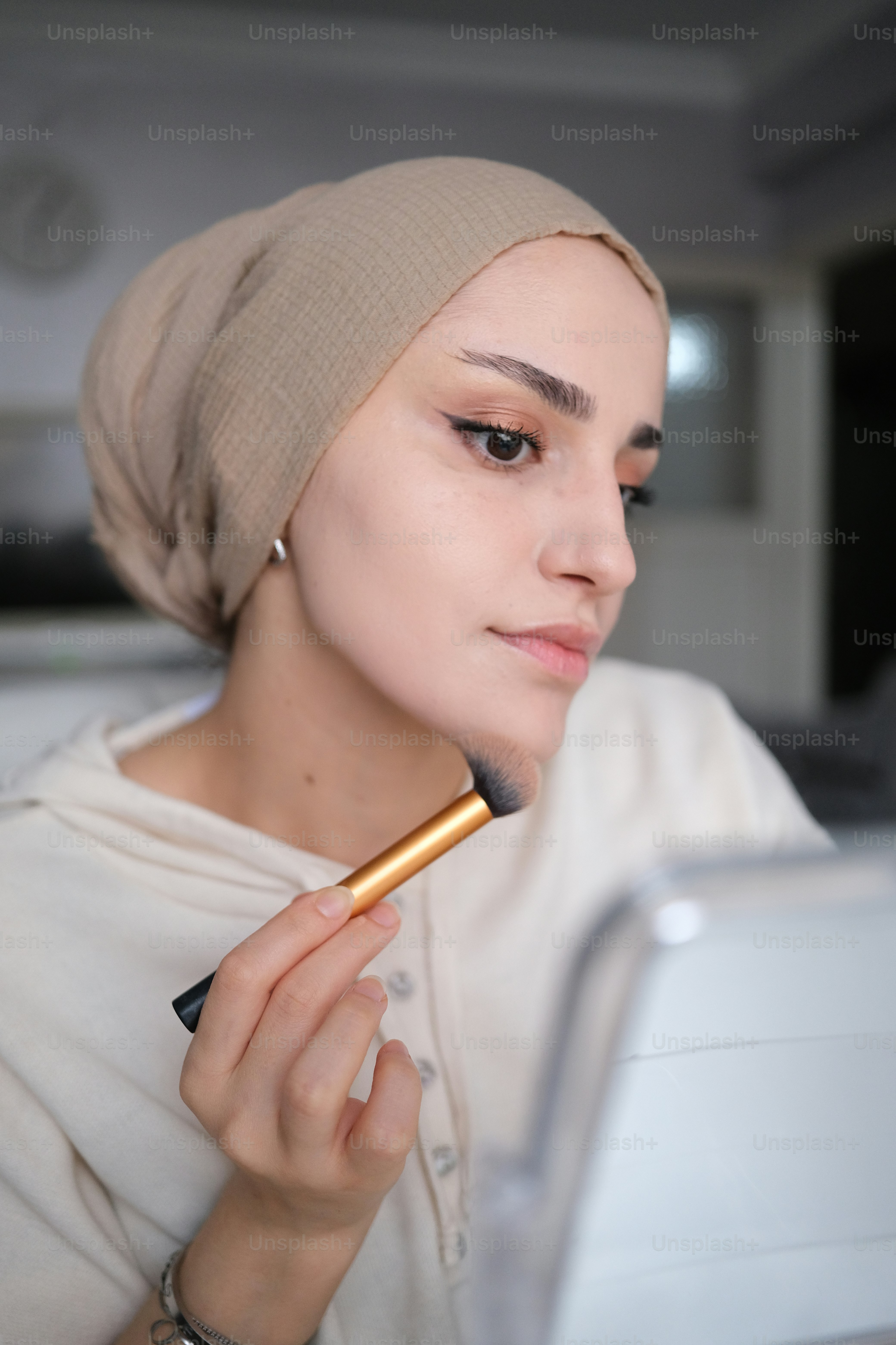 a woman with a turban is looking at a laptop