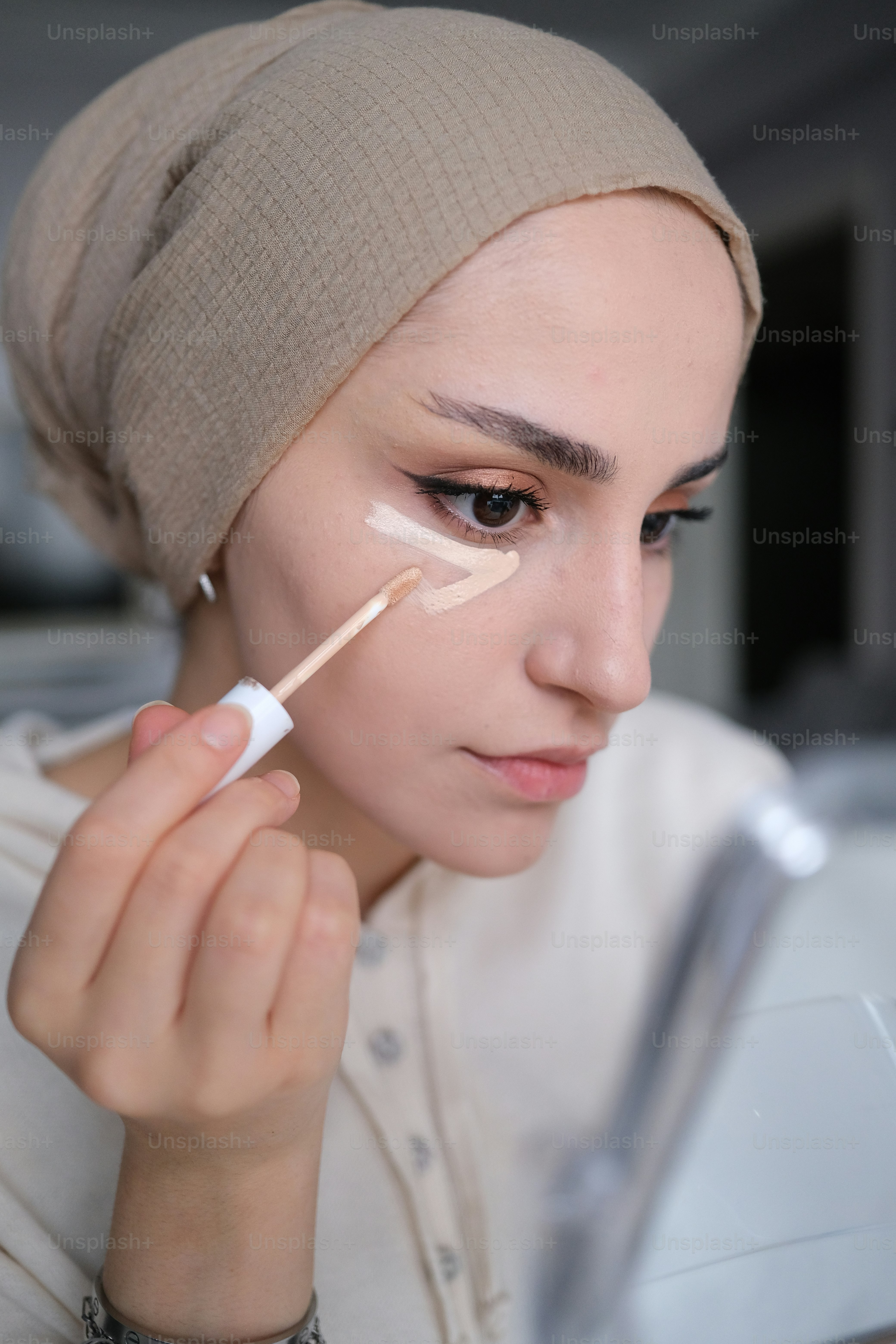 a woman with a turban on her head and a brush in her hand