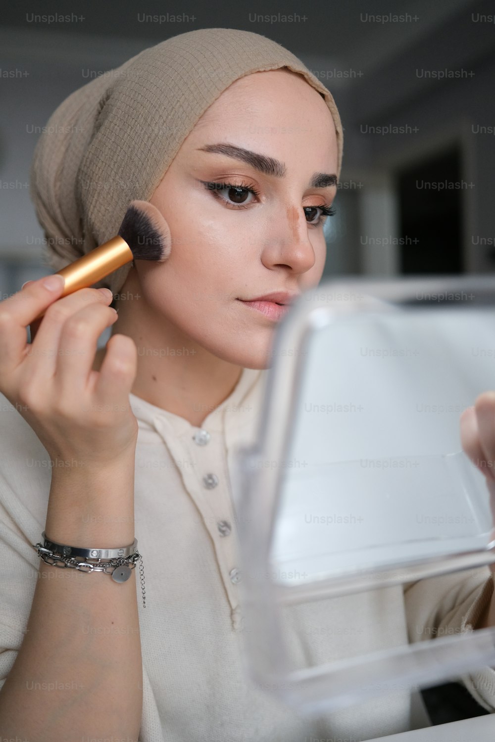 a woman with a makeup brush in her hand