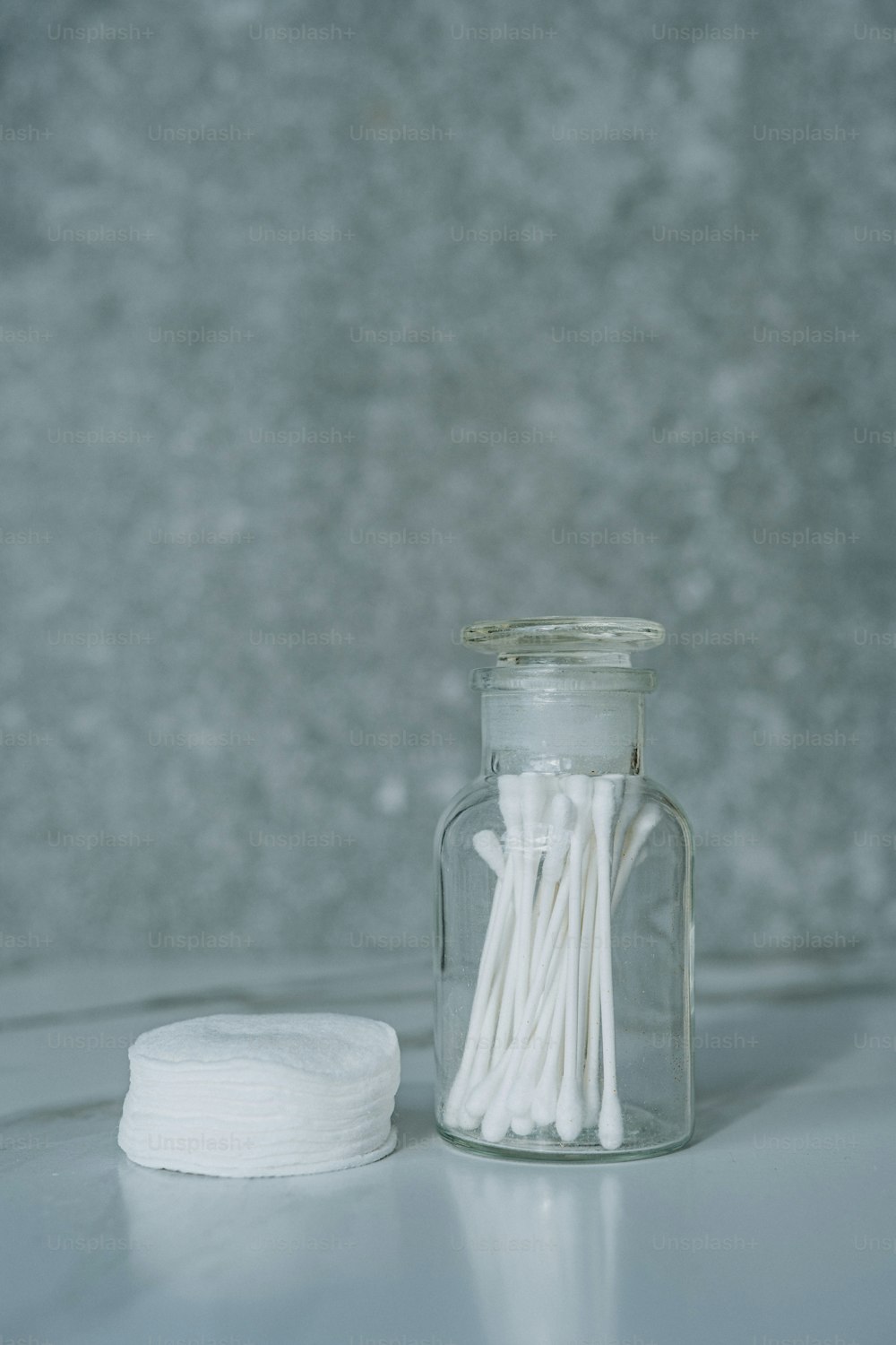 a glass jar filled with white cotton swabs