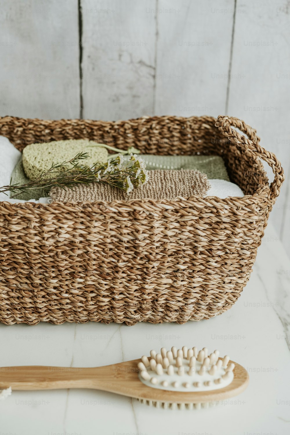 a wicker basket with a brush and soap on it