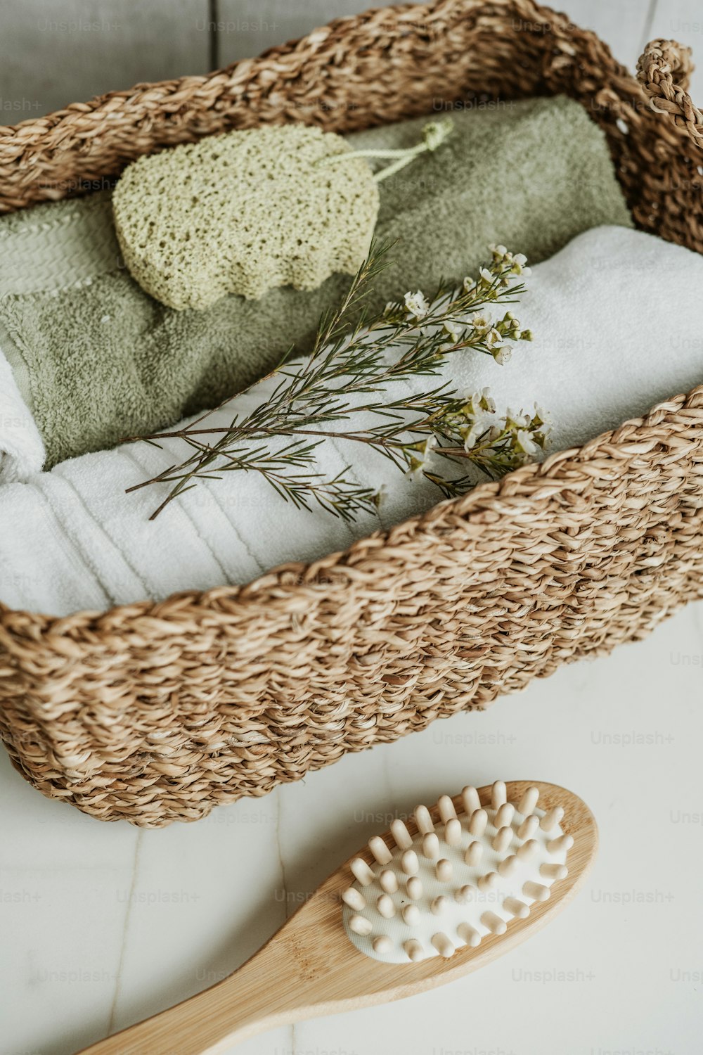 a basket with towels and a brush on the floor