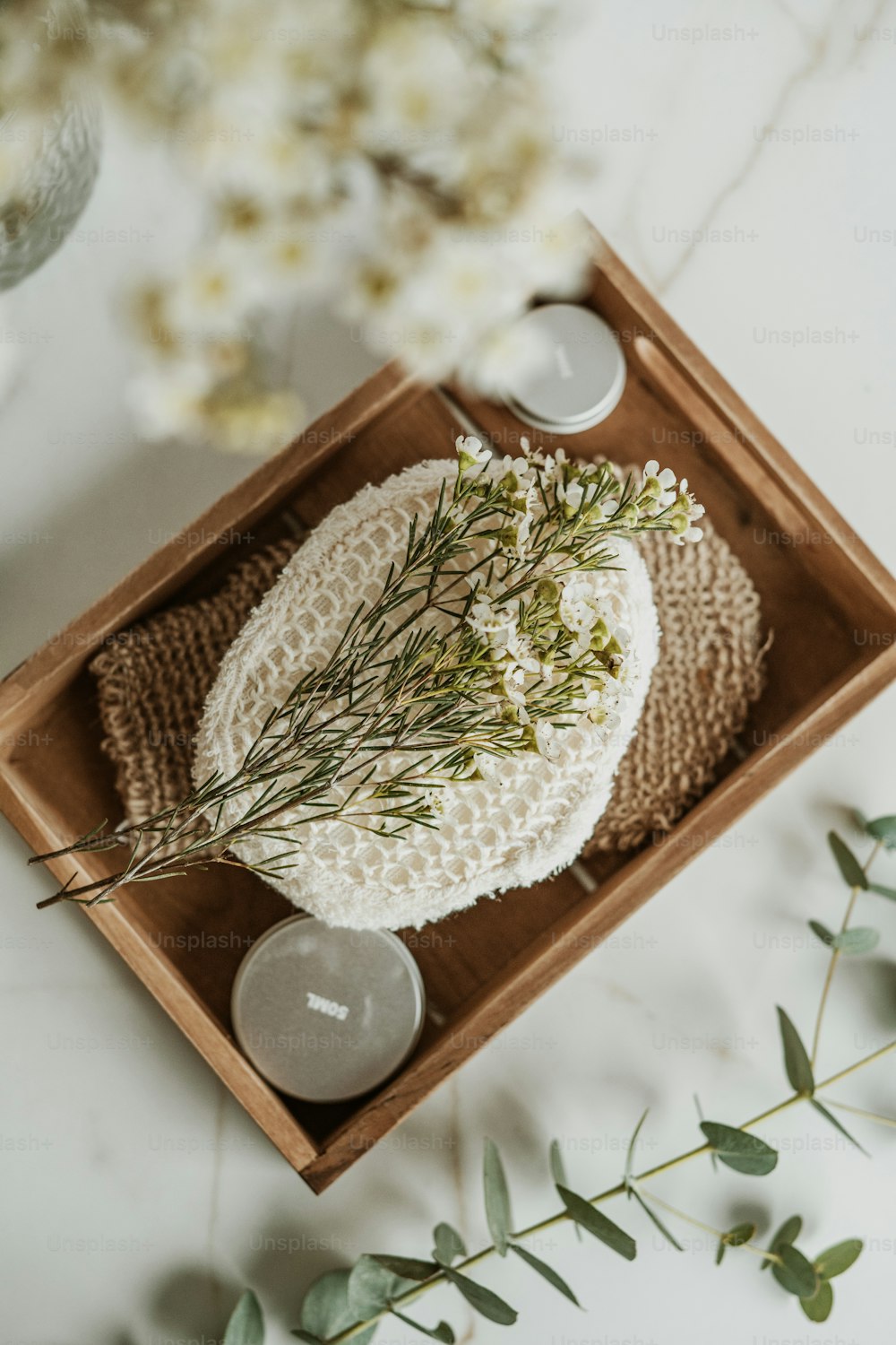 a wooden tray with a knitted hat and candles