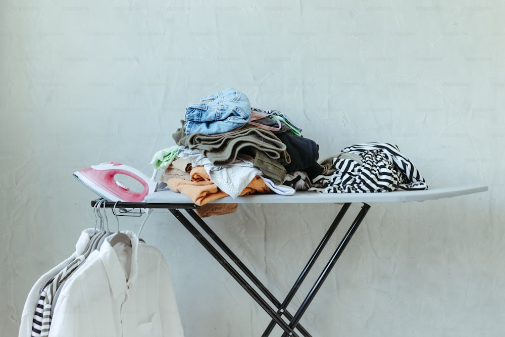 a ironing board with clothes on top of it