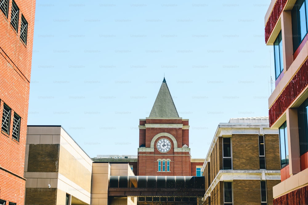 a clock tower in the middle of a courtyard