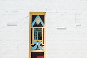 a white building with a blue and yellow window