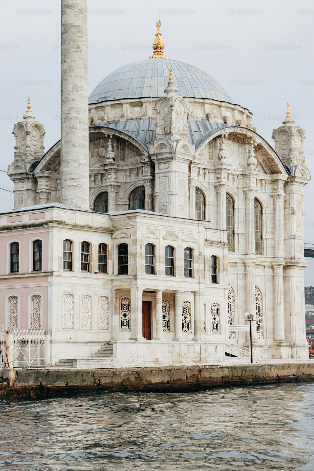 a large white building sitting on top of a body of water