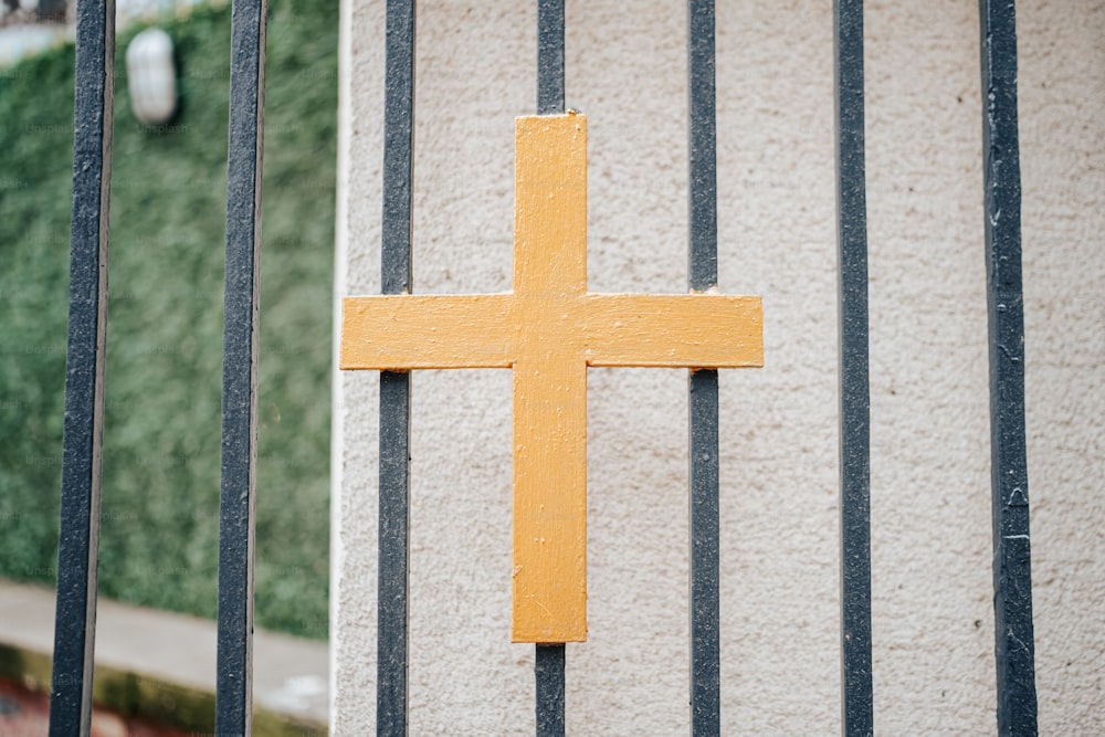 a yellow cross on the side of a building