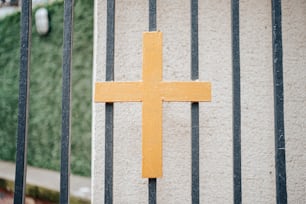 a yellow cross on the side of a building