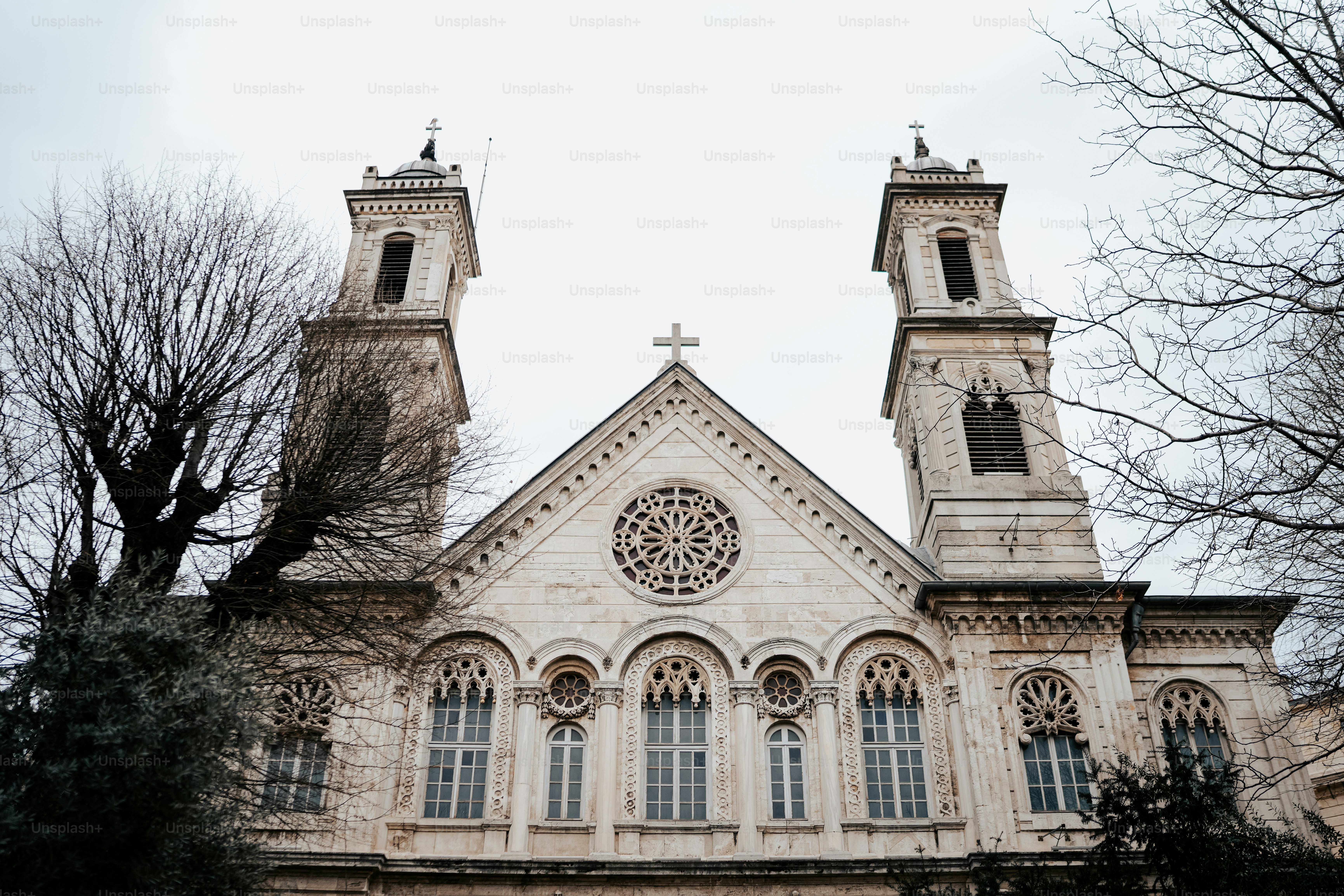 a church with two towers and a cross on top