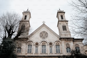 a church with two towers and a cross on top