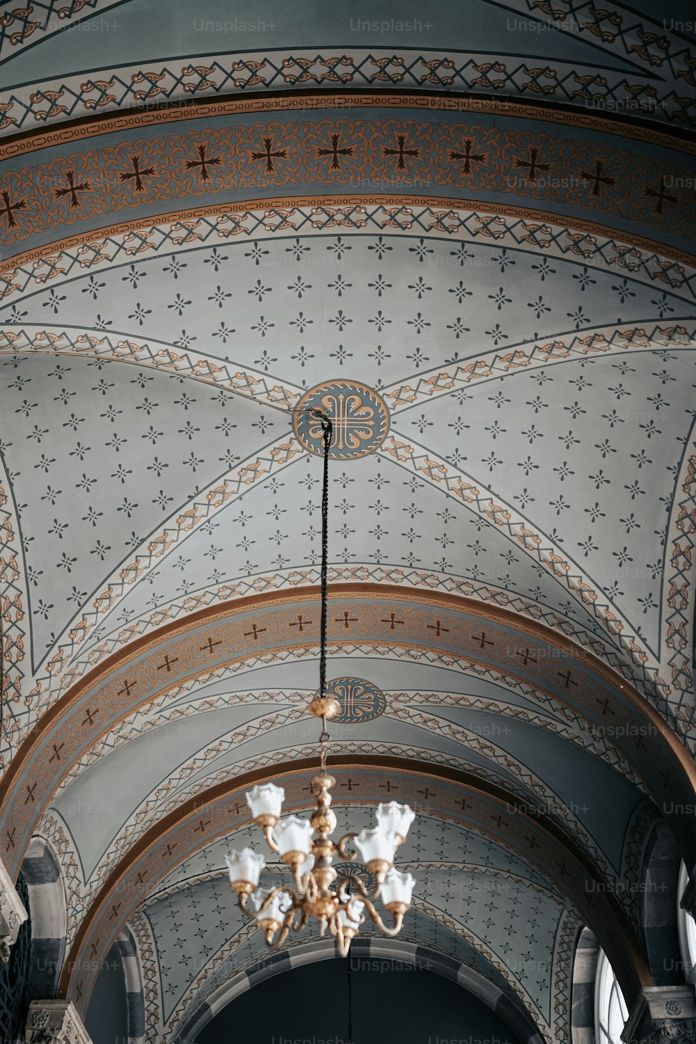 a chandelier hanging from the ceiling of a church