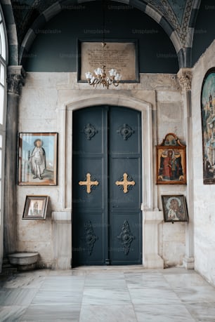 a blue door in a room with paintings on the wall
