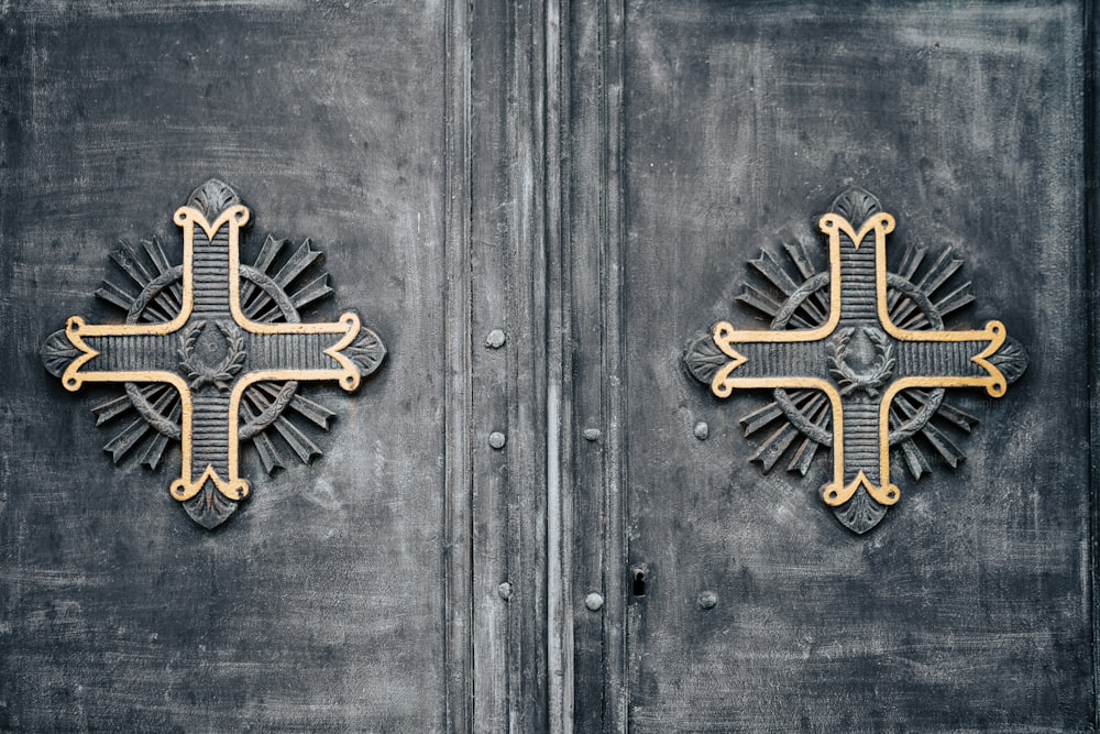 two metal doors with decorative designs on them