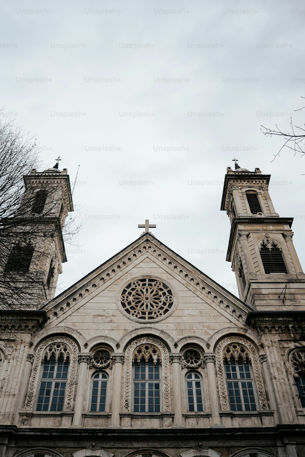 a church with two towers and a clock on the front of it