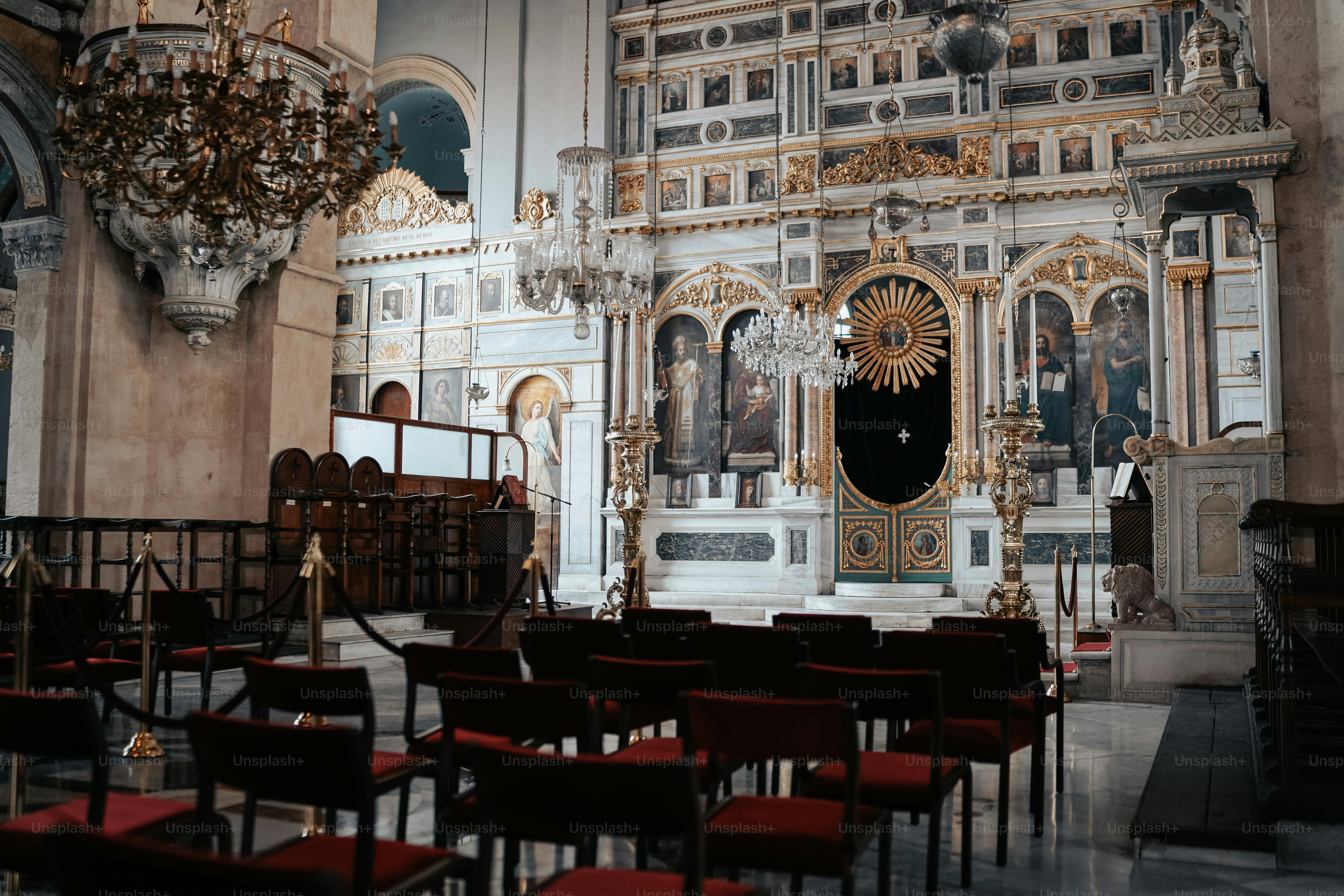 a church filled with lots of chairs and a chandelier