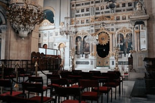 a church filled with lots of chairs and a chandelier