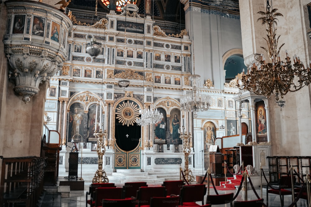 a church with a chandelier and chairs inside of it