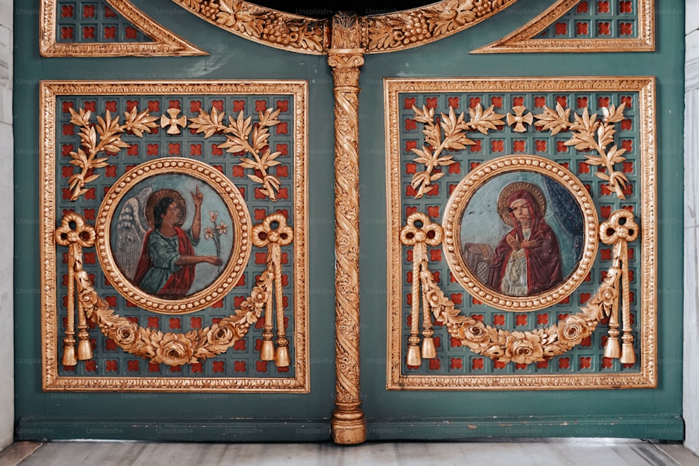 a close up of a door with paintings on it