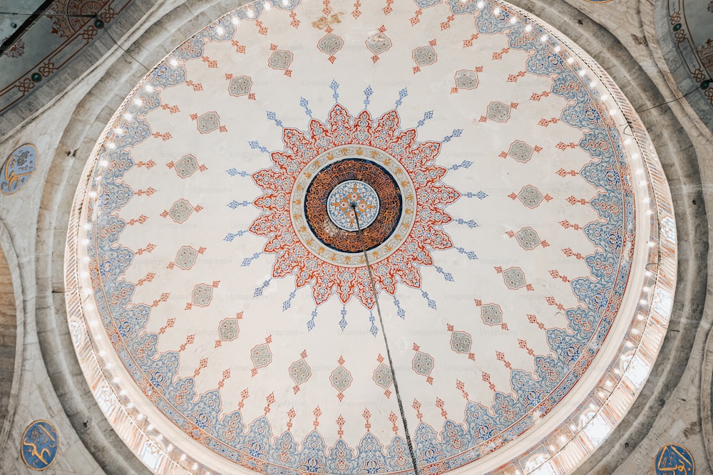 the ceiling of a building with a circular design on it