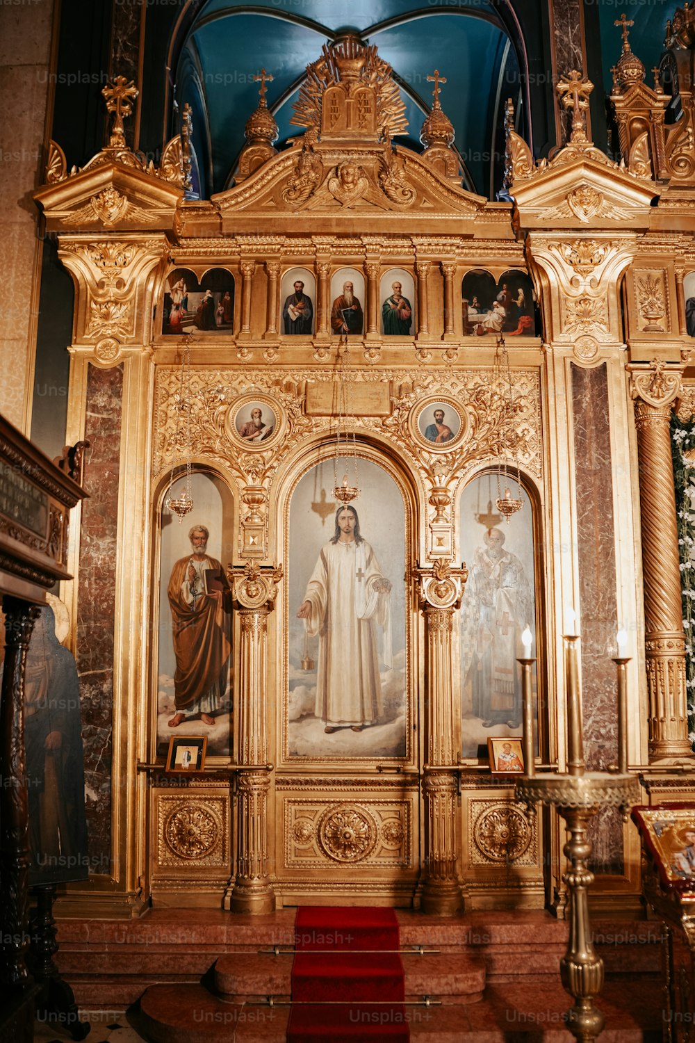 a church alter with a painting of a woman and two men