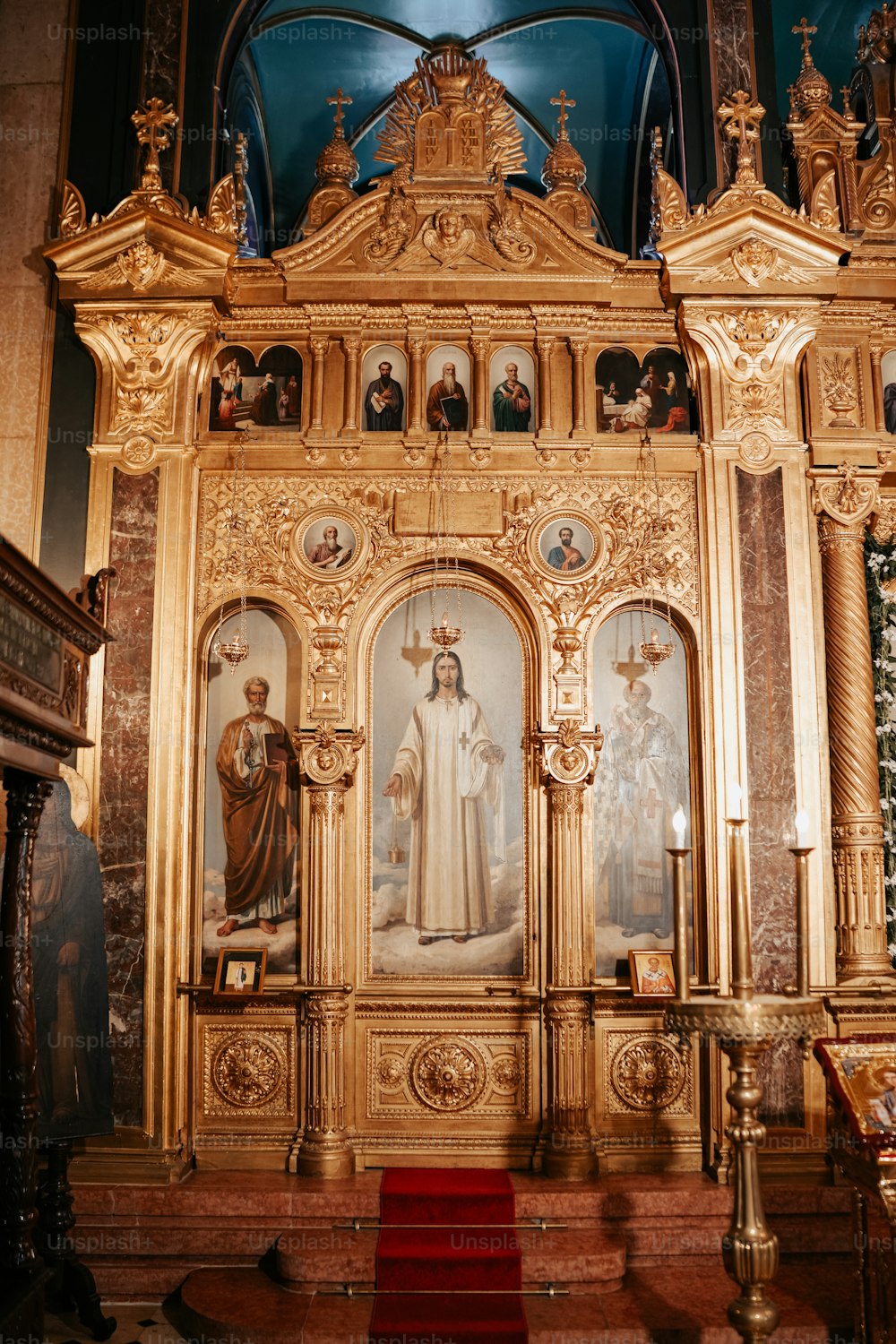 a church alter with a painting of a woman and two men