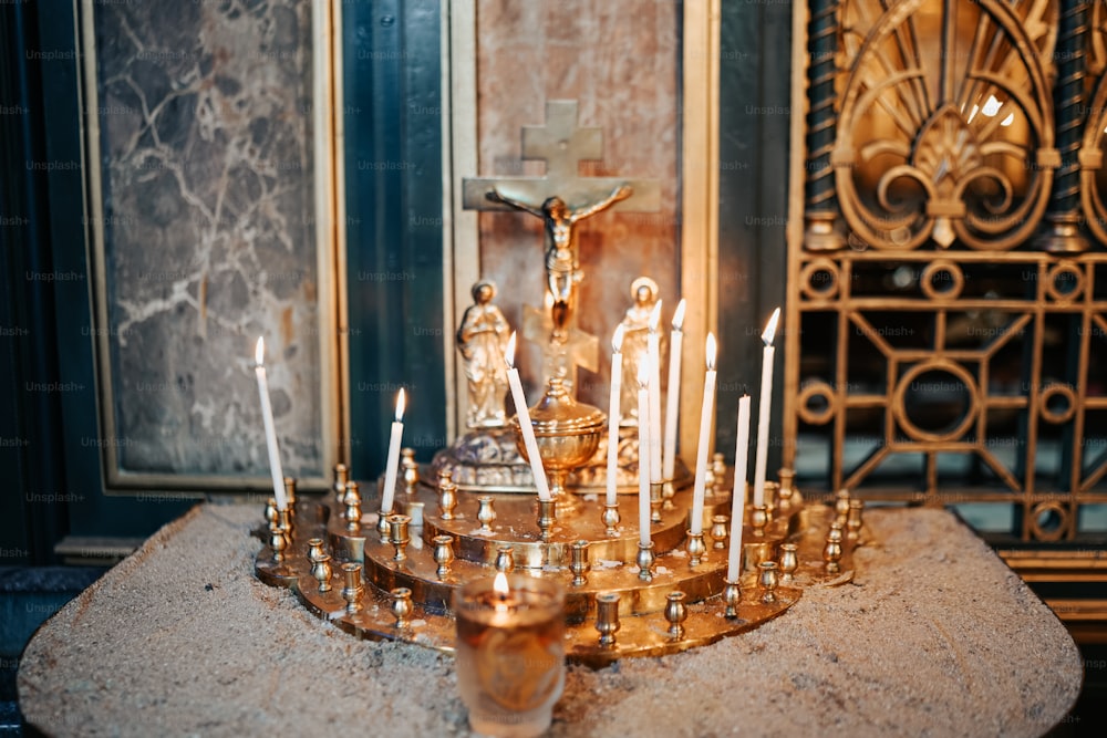 a candle holder with many candles on a table