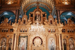 Una iglesia con una lámpara de araña y pinturas en la pared