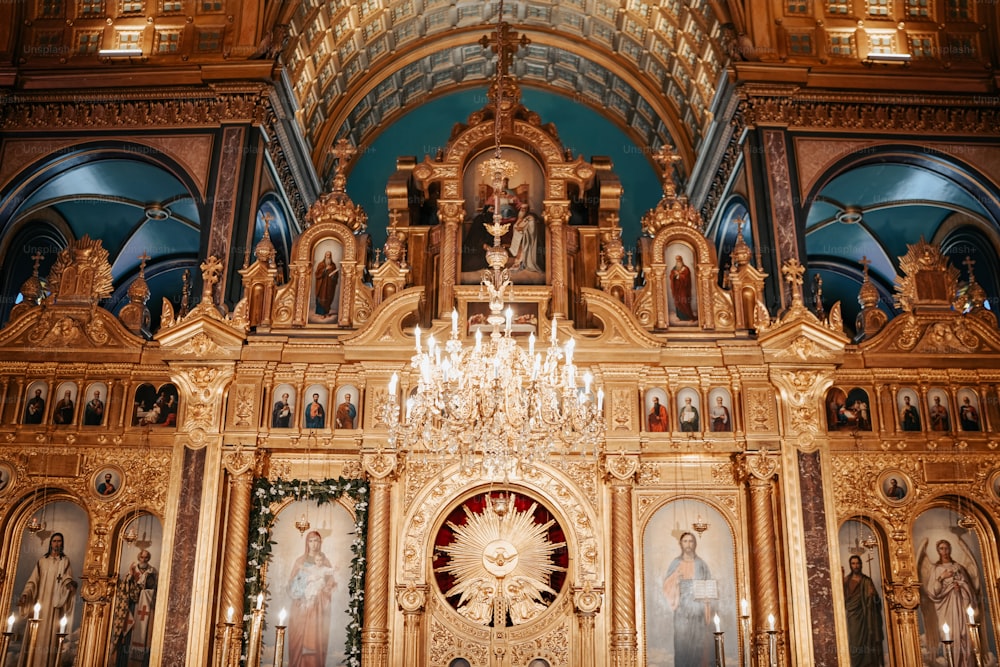 a church with a chandelier and paintings on the wall