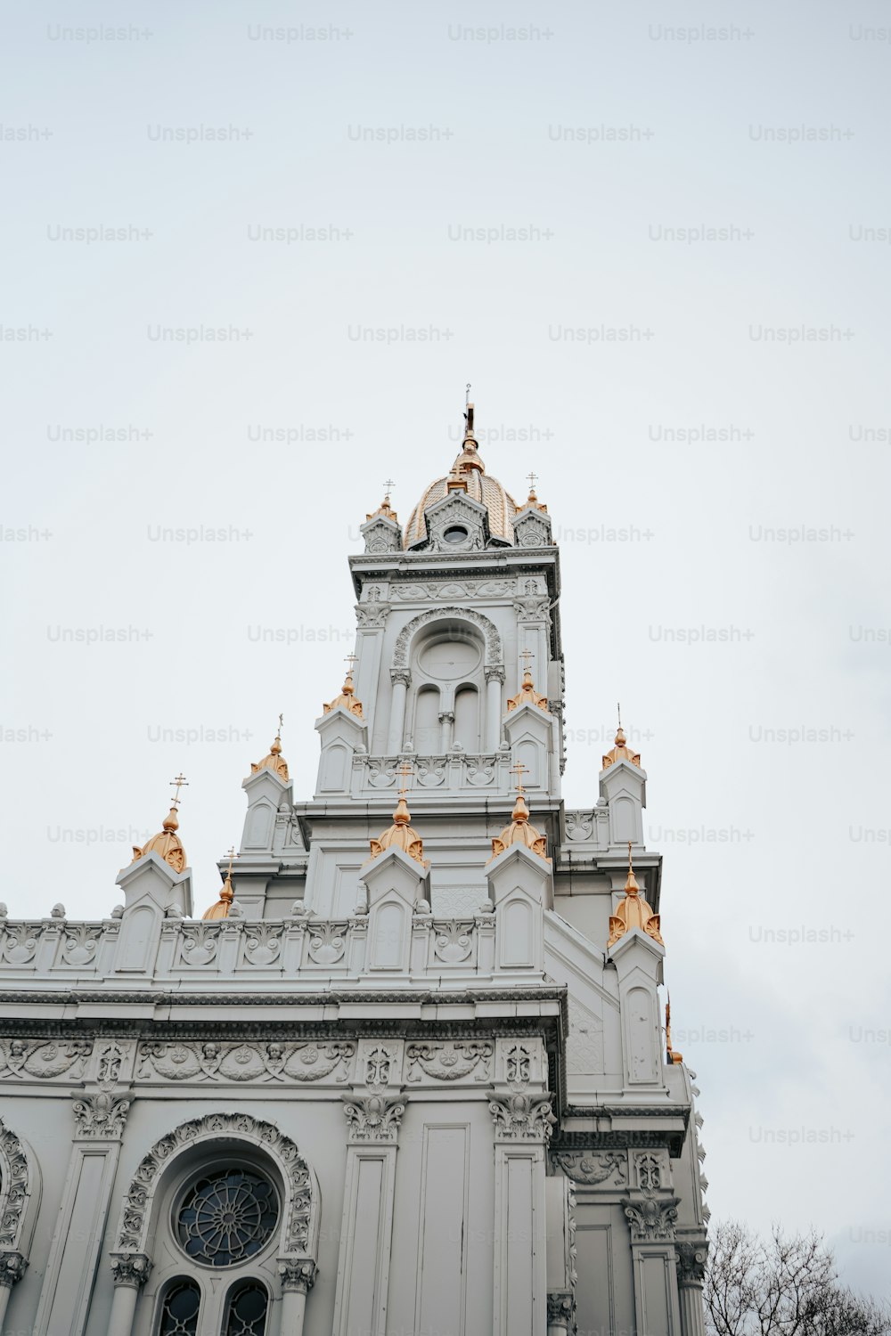 a tall white building with a clock on it's side