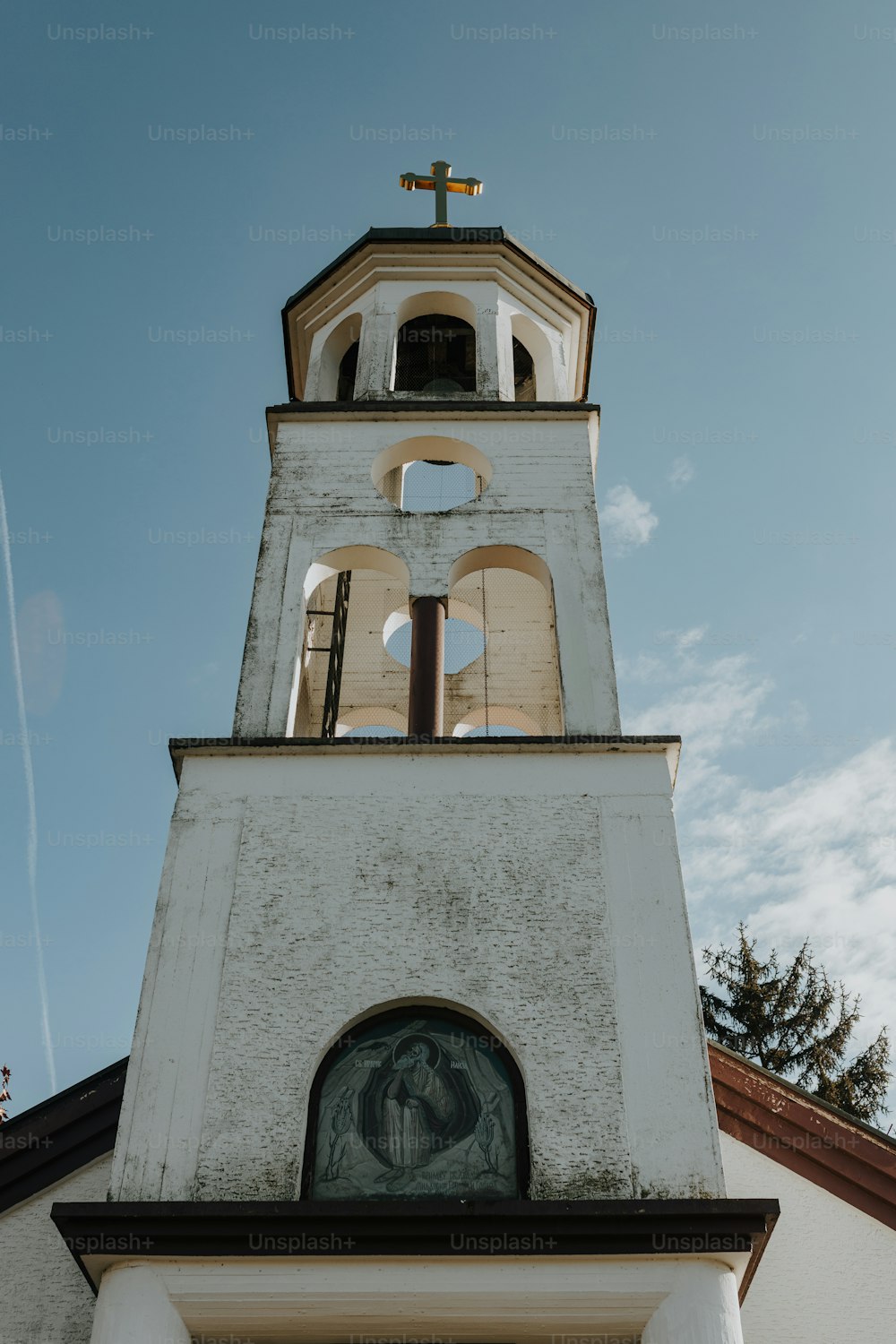 a tall white tower with a clock on it's side