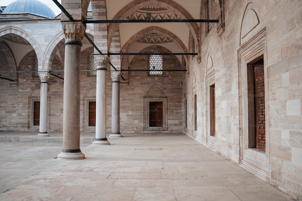 a large building with columns and a clock on the wall