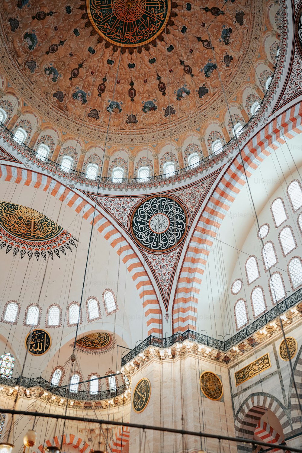 the ceiling of a large building with many windows