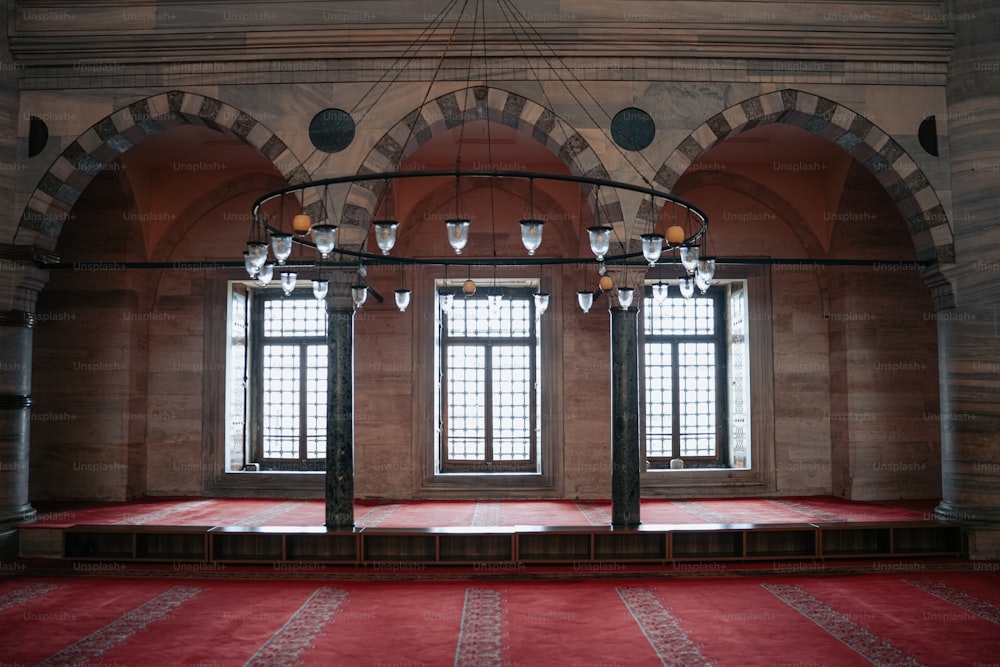 a room with a red carpet and a chandelier