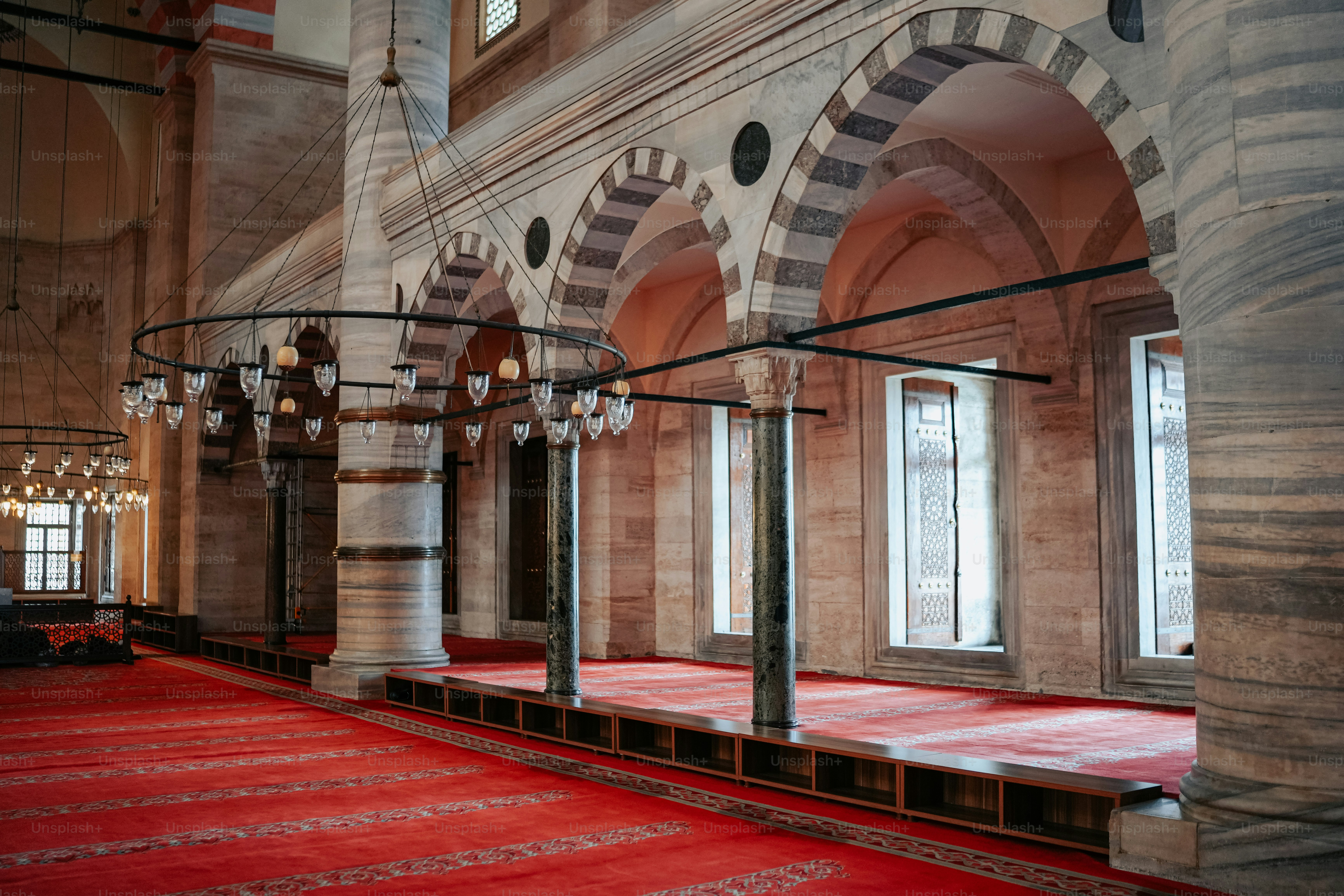 a large room with a red carpet and chandelier
