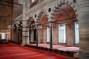 a large room with a red carpet and chandelier