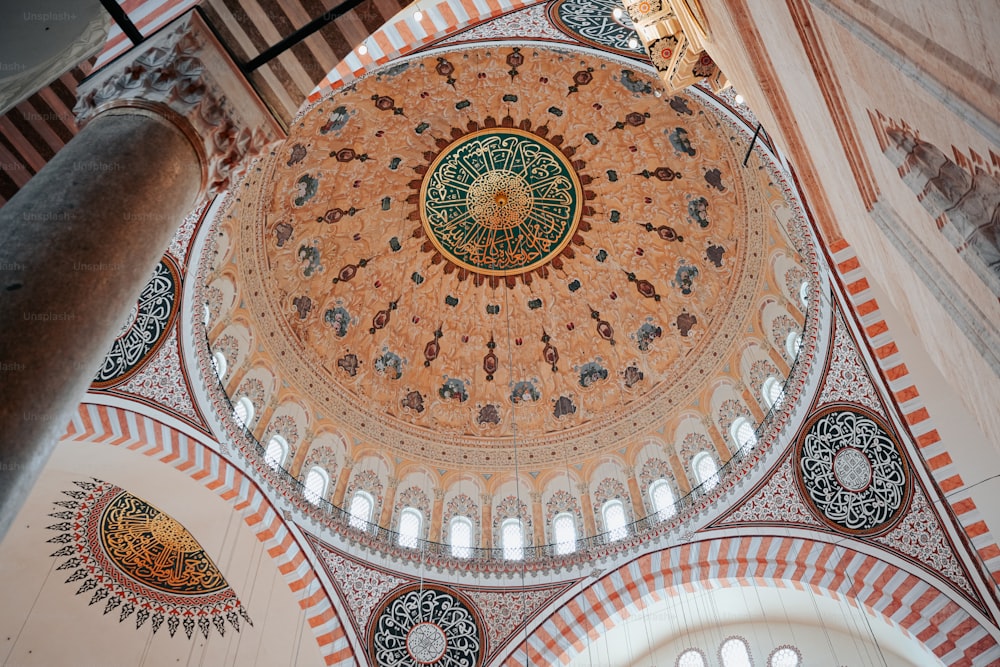 the ceiling of a large building with a circular design on it