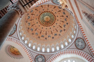 the ceiling of a large building with a circular design on it
