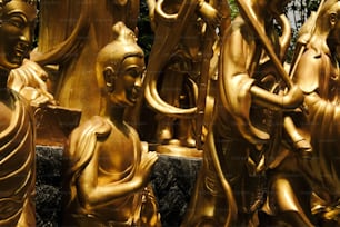 a group of golden statues sitting next to each other