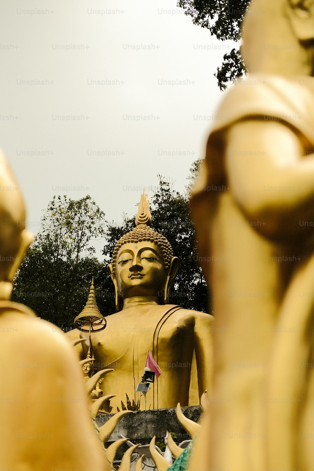 a statue of a buddha surrounded by other statues