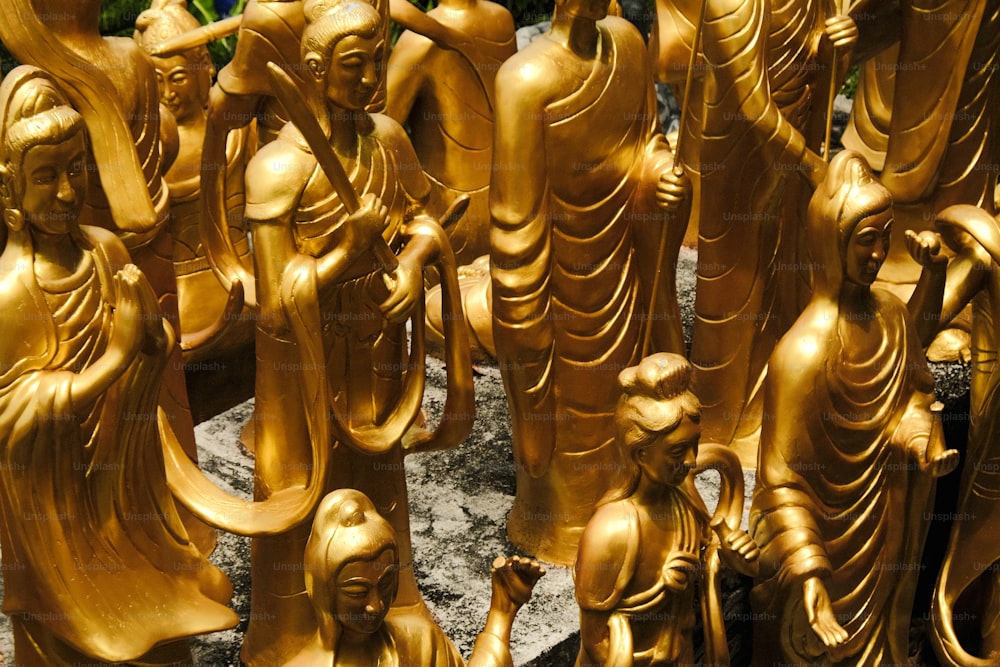 a group of golden statues sitting next to each other