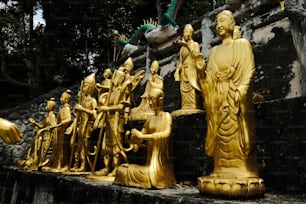 a group of golden statues sitting next to each other