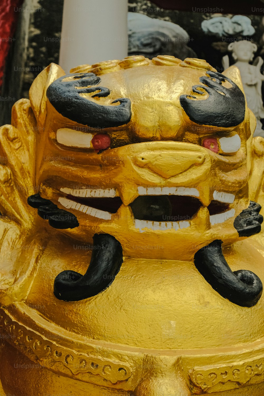 a yellow fire hydrant with a face painted on it