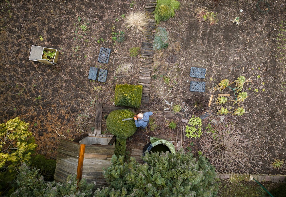 an aerial view of a man working in a garden