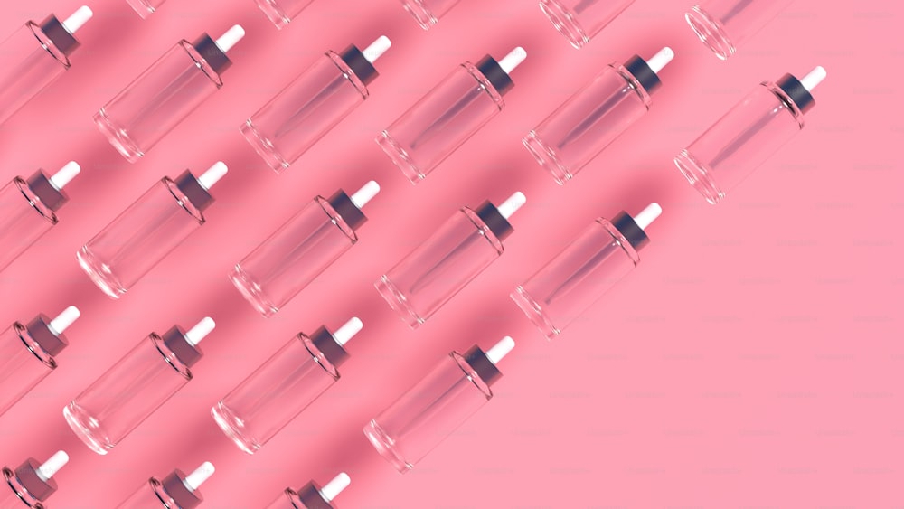 a pink background with a row of glass tubes