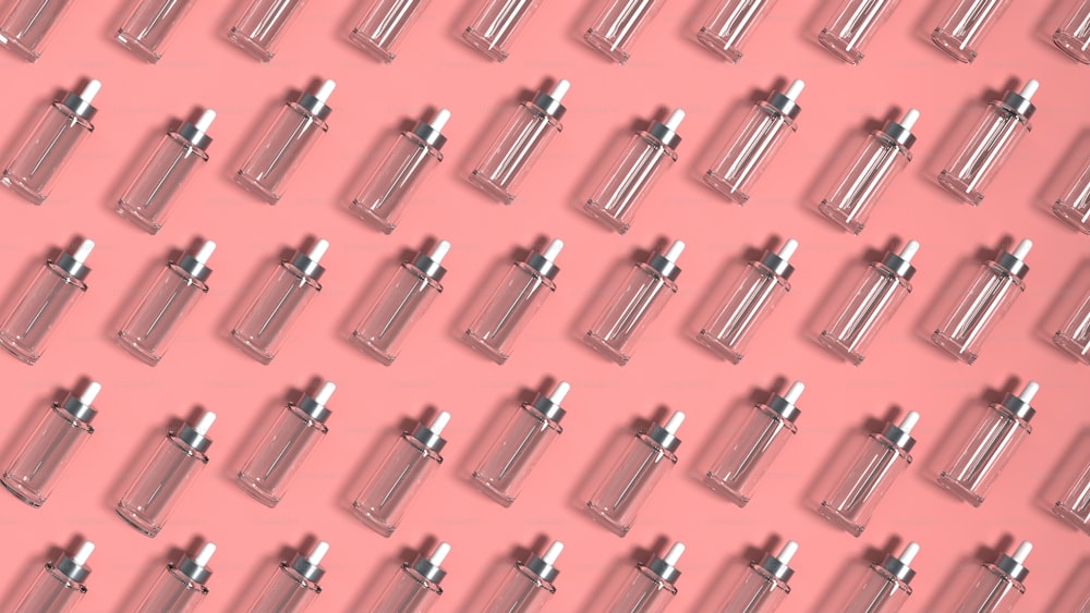 a pink background with a lot of silver bottles