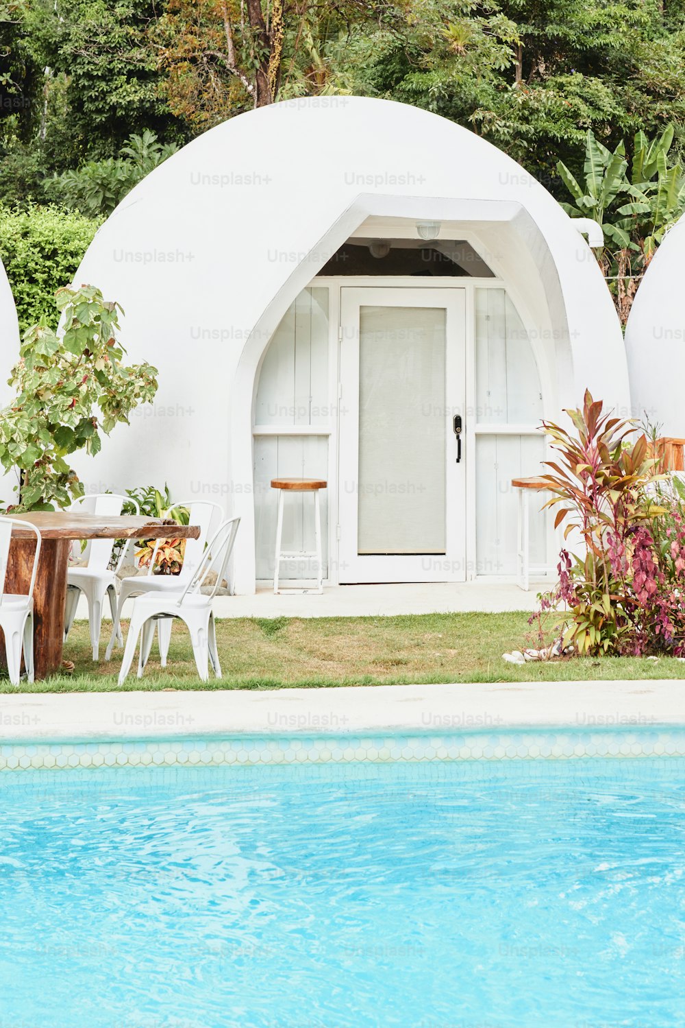 a pool with a table and chairs next to it