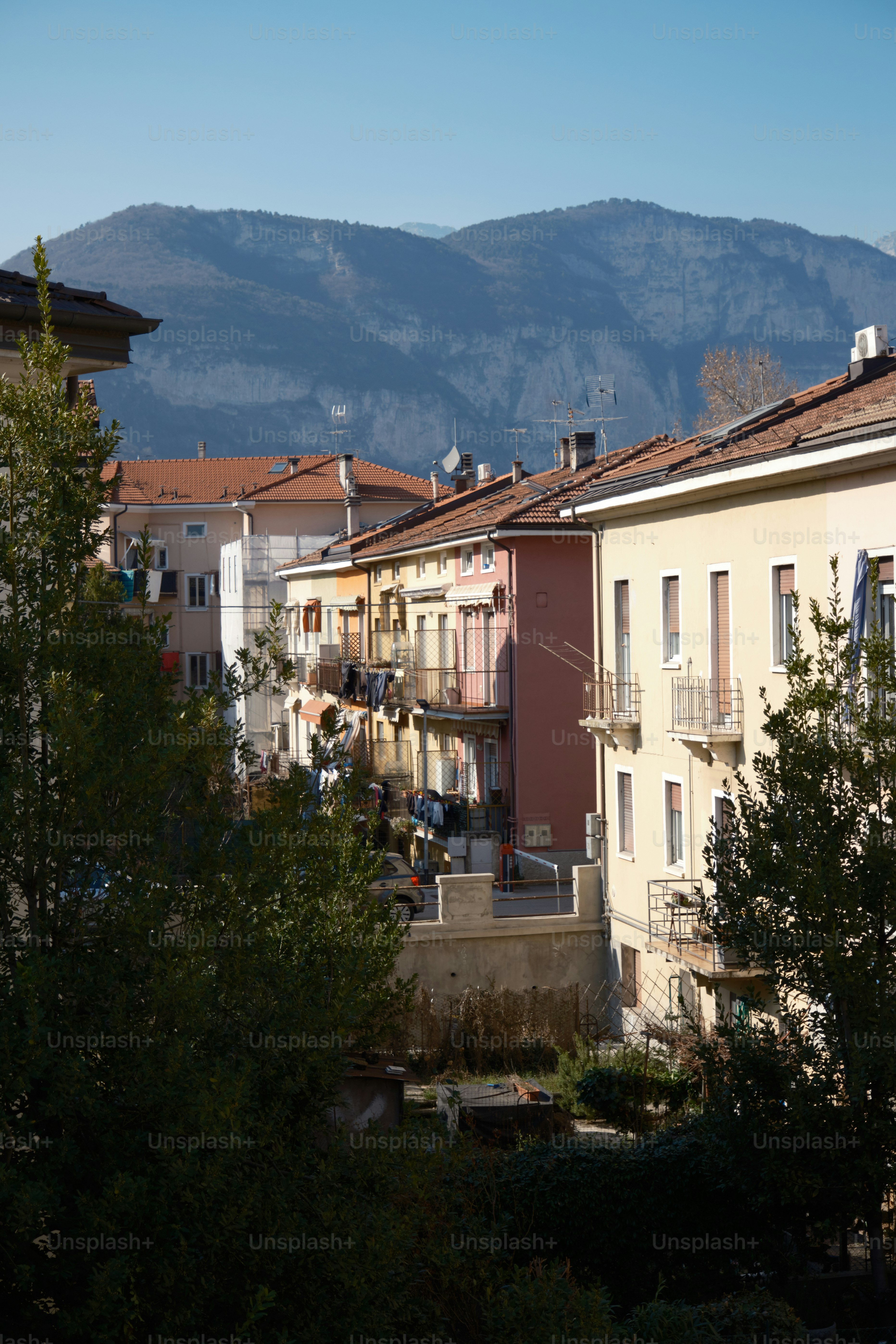 a row of buildings with a mountain in the background